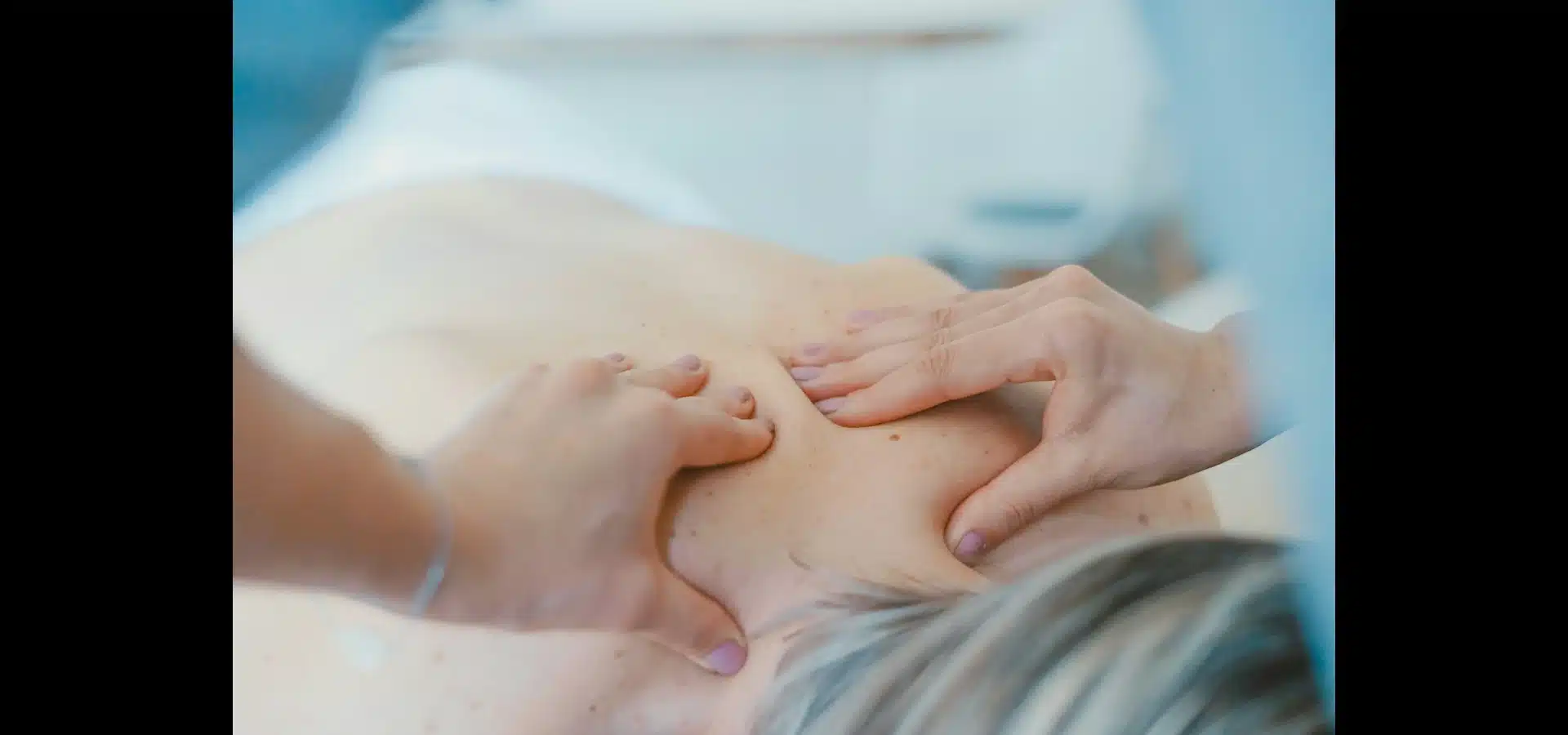 Physical therapist guiding a patient during a clinic exercise